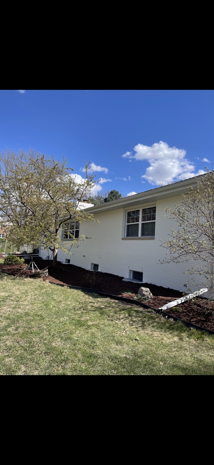 White painted brick exterior after painting by AJC Painting