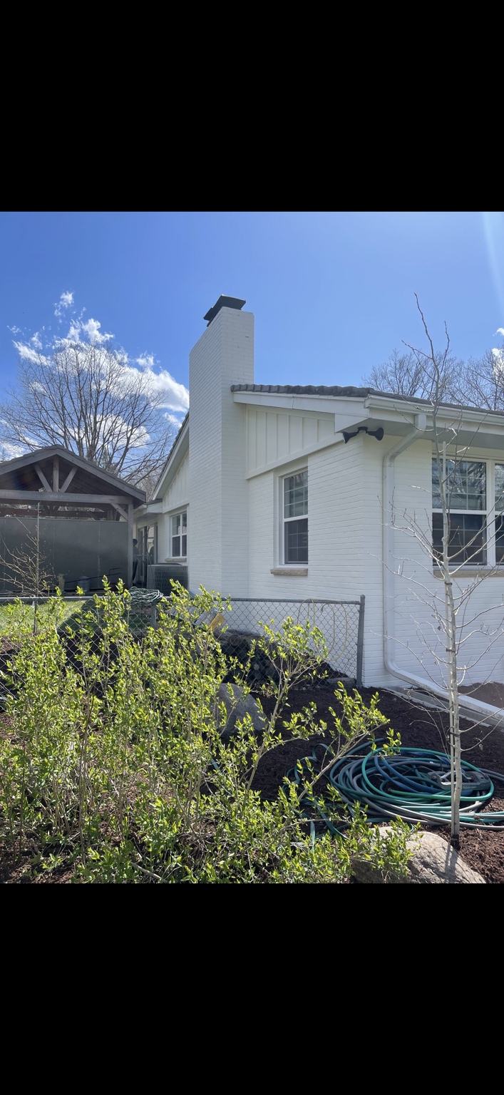 White painted brick chimney and exterior wall