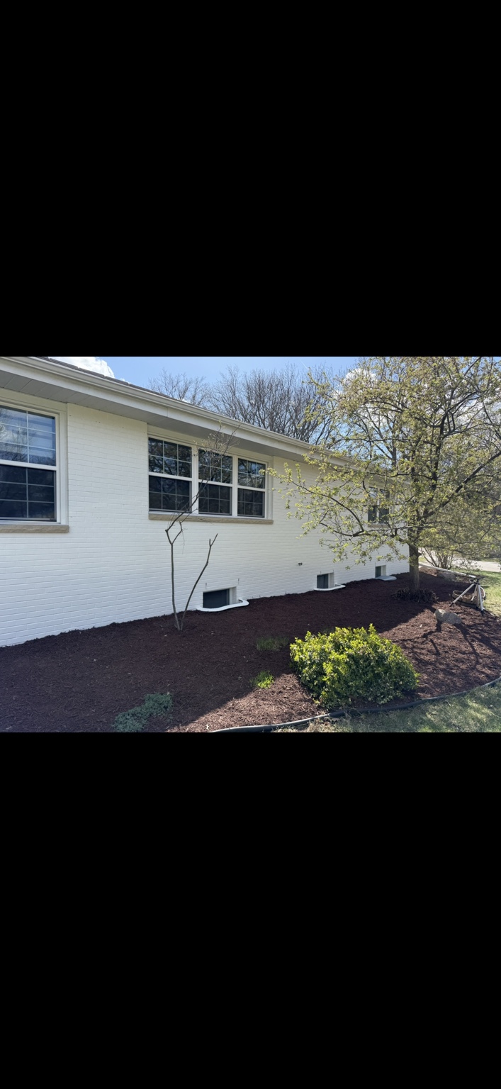 Finished white brick along the side of the home