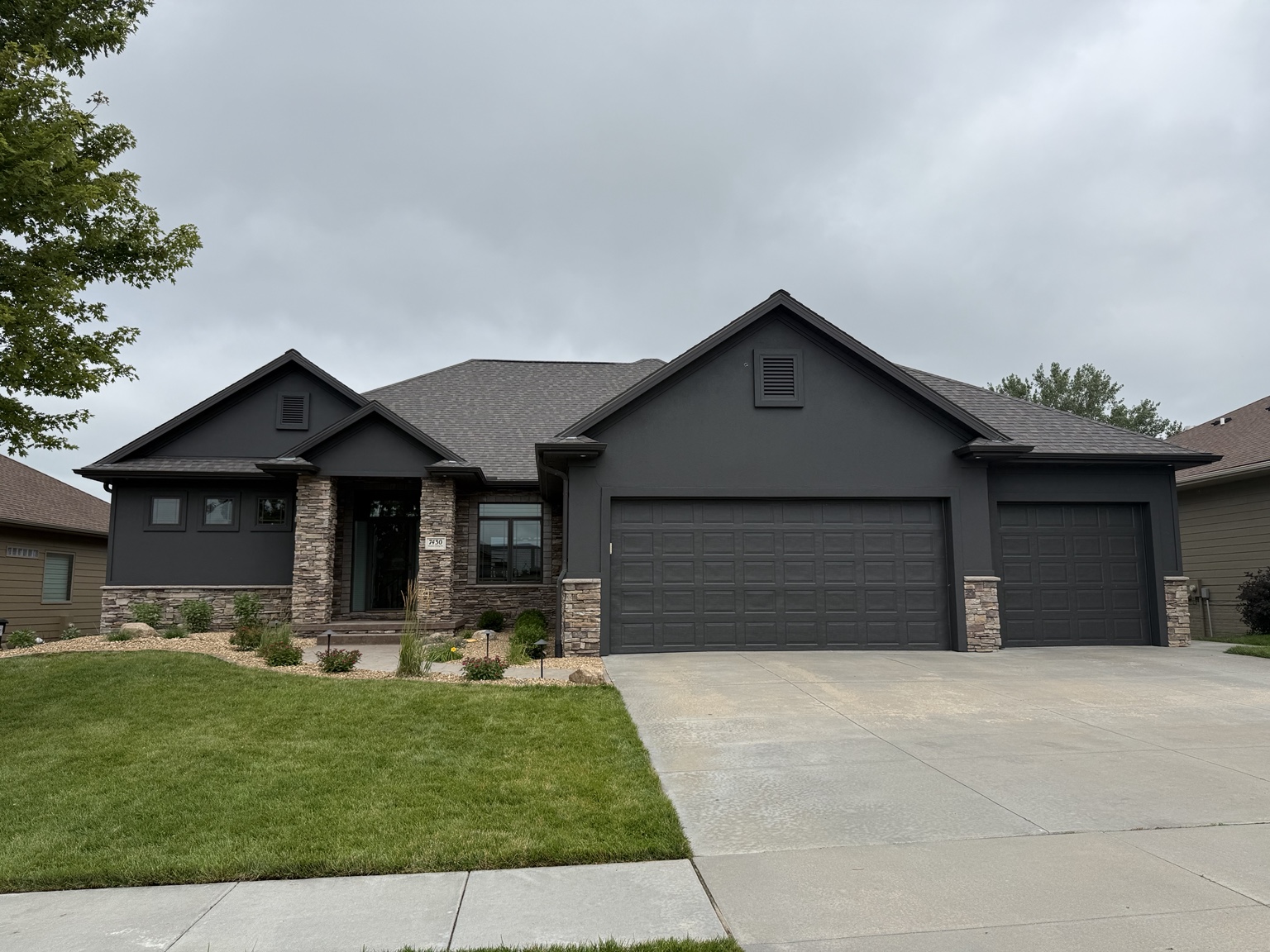 Charcoal front exterior and garage doors painted by AJC Painting