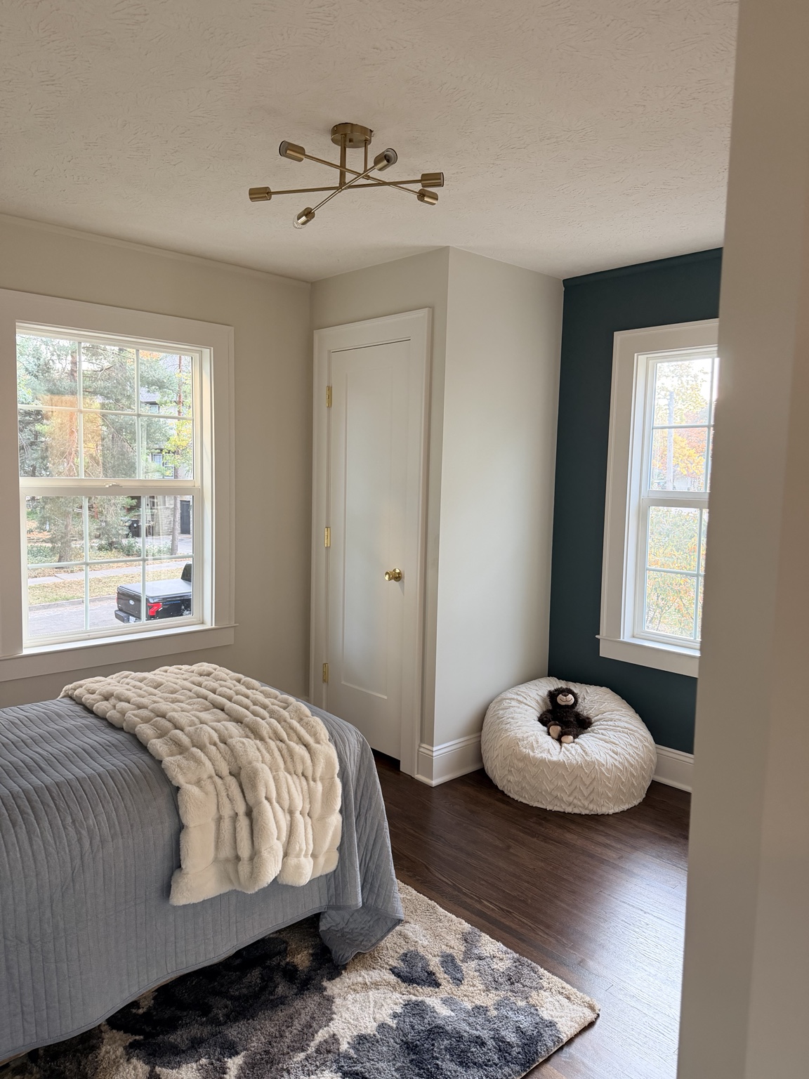 Bedroom with a deep teal accent wall