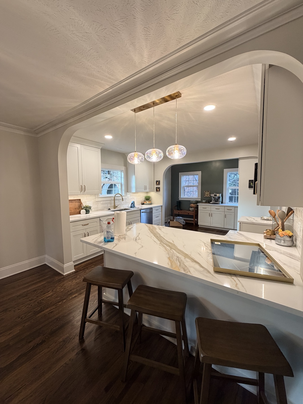 Kitchen viewed through an arched opening