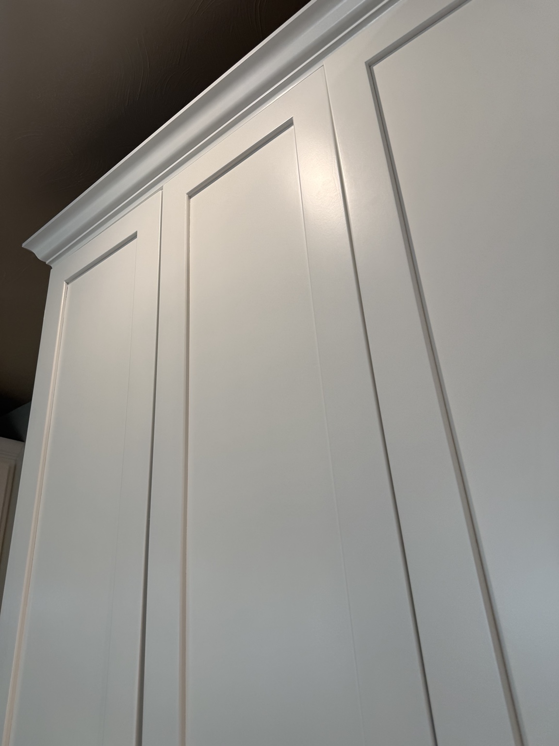 Close view of refinished cabinet doors and crown molding
